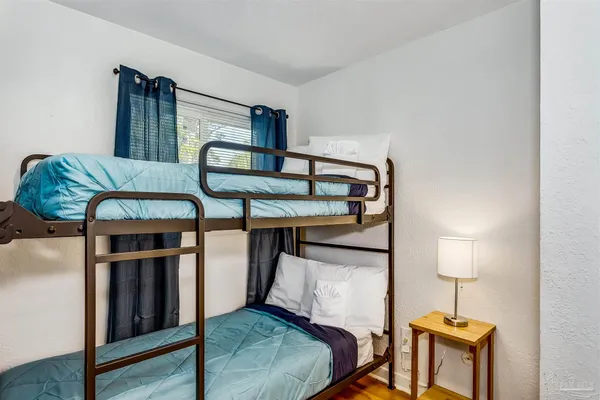 a bedroom with furniture and a window