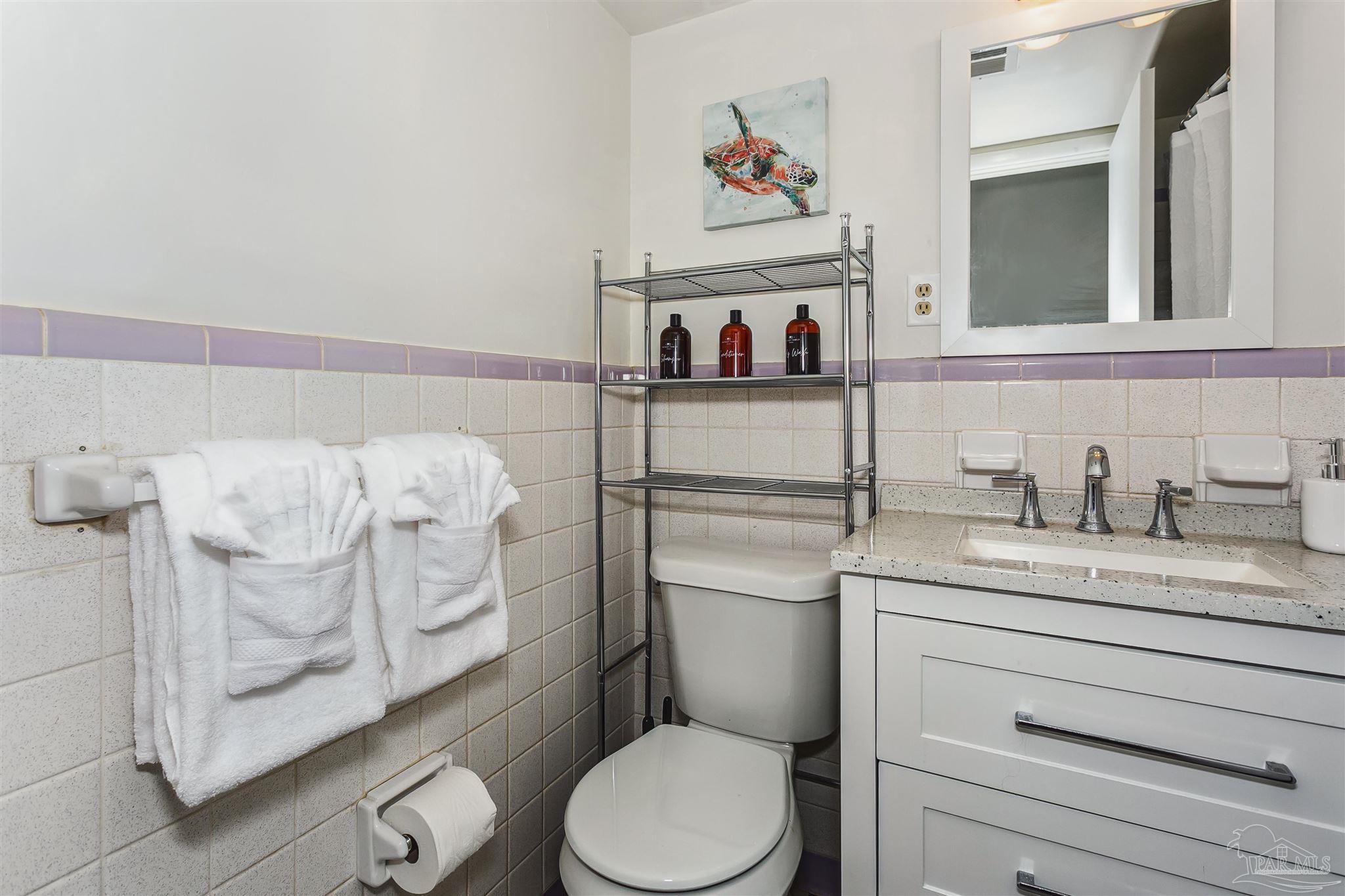 6 Ruffin Circle Pensacola, FL 32503 - Photo 25 of 42 a bathroom with a toilet sink vanity and mirror