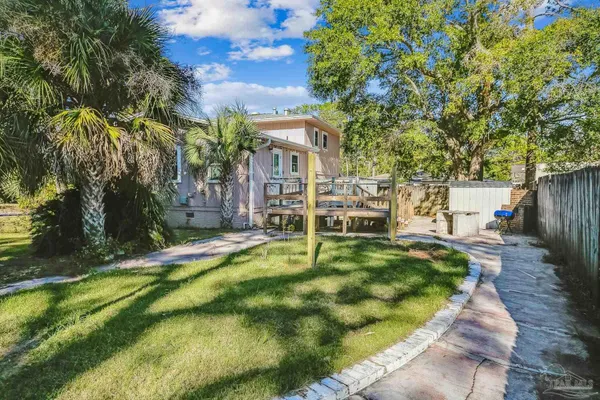 a view of a house with backyard porch and sitting area
