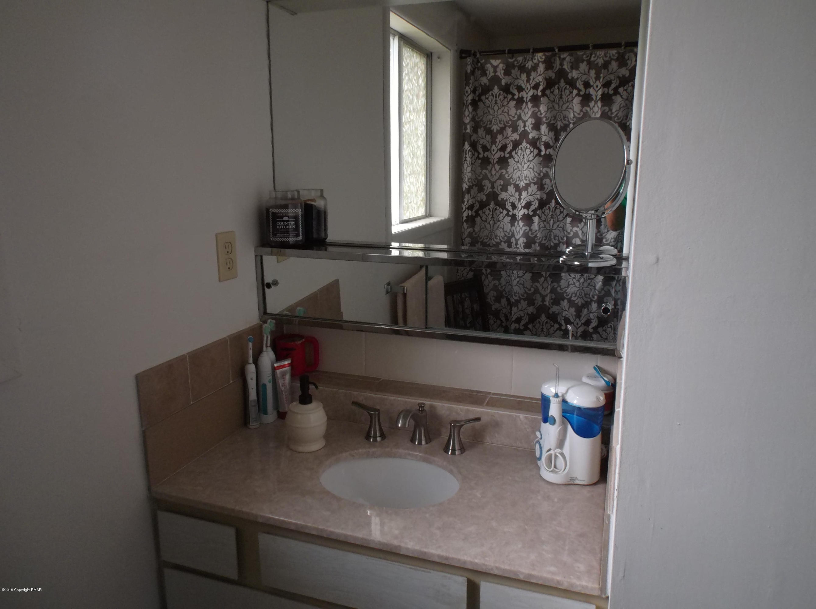 3430 Walnut Road Kunkletown, PA 18058 - Photo 6 of 16 a bathroom with a granite countertop sink and a mirror