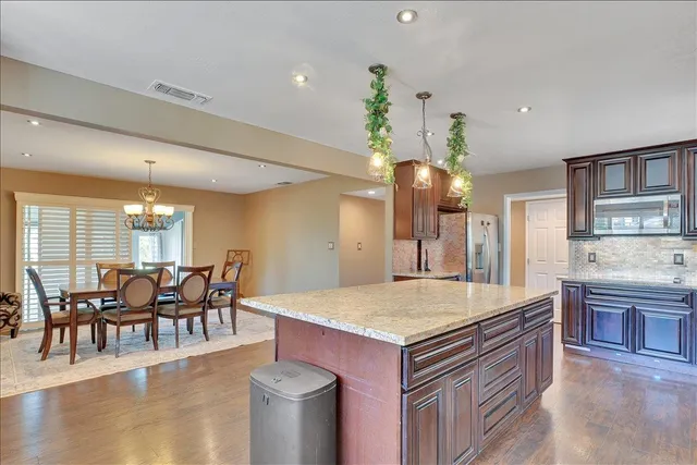 a large kitchen with a table and chairs