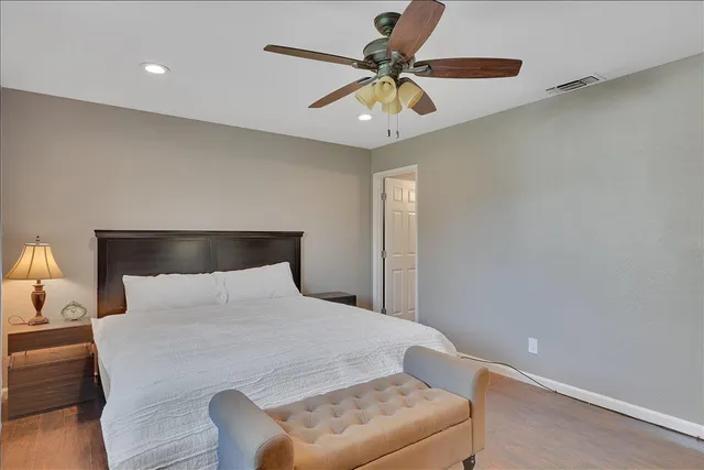 a bathroom with a granite countertop bathtub shower sink and a mirror