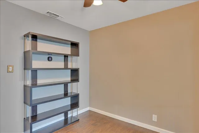 a view of an empty room with a ceiling fan