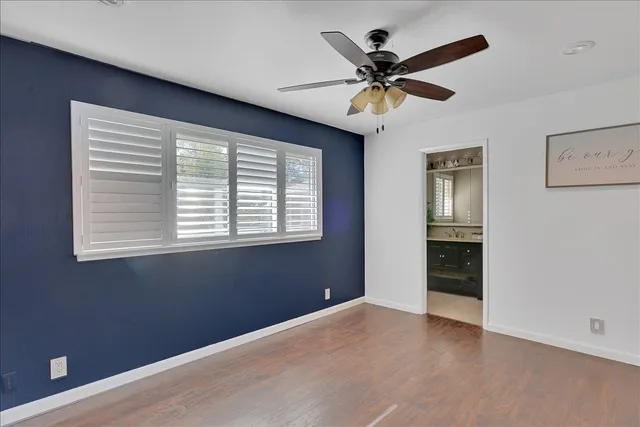 a view of backyard with potted plants and wooden fence