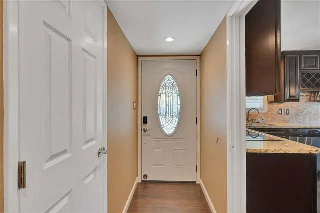 a kitchen with granite countertop a sink and a large window