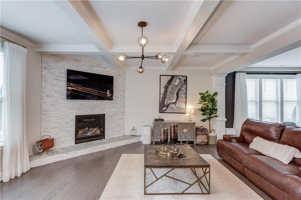542 Flyingbolt Run Canton, GA 30115 - Photo 11 of 55 a living room with furniture a flat screen tv and a fireplace