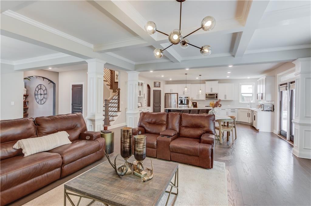542 Flyingbolt Run Canton, GA 30115 - Photo 12 of 55 a living room with furniture kitchen view and a wooden floor