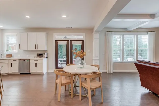 a kitchen with kitchen island granite countertop a table and chairs in it