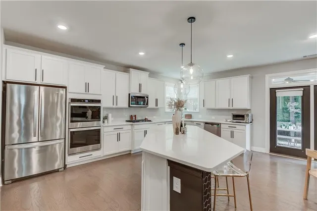 a view of a kitchen counter top space with granite countertop stainless steel appliances