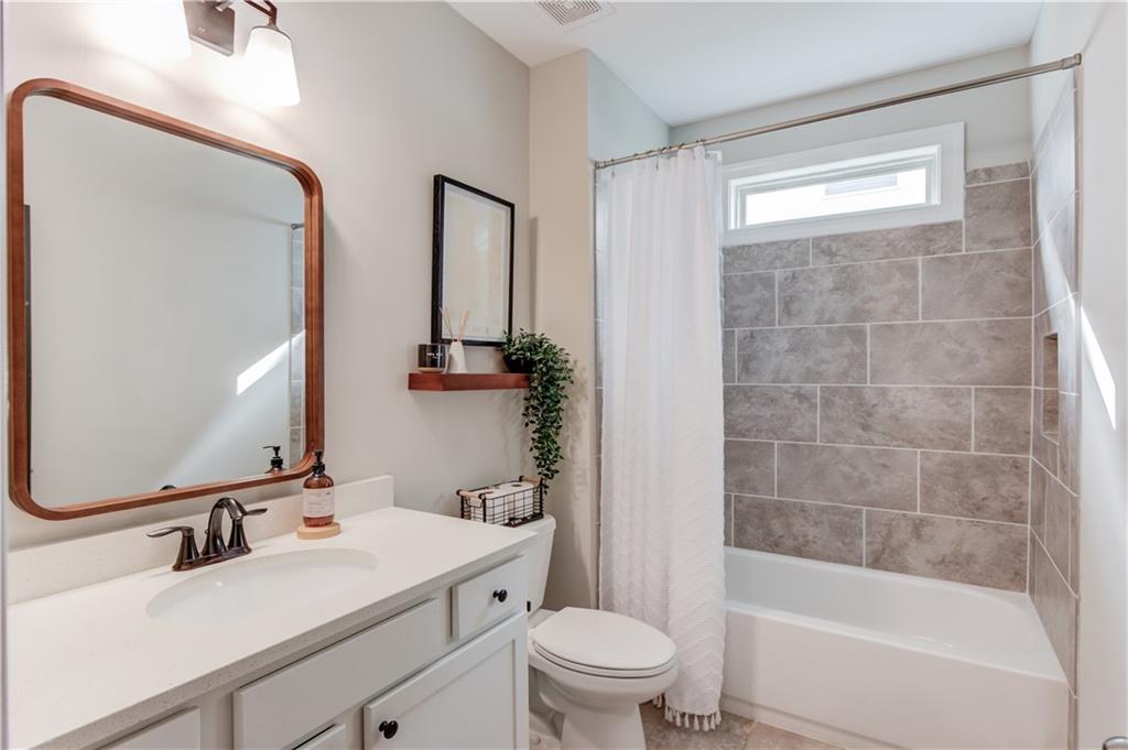542 Flyingbolt Run Canton, GA 30115 - Photo 18 of 55 a bathroom with a sink toilet tub and shower