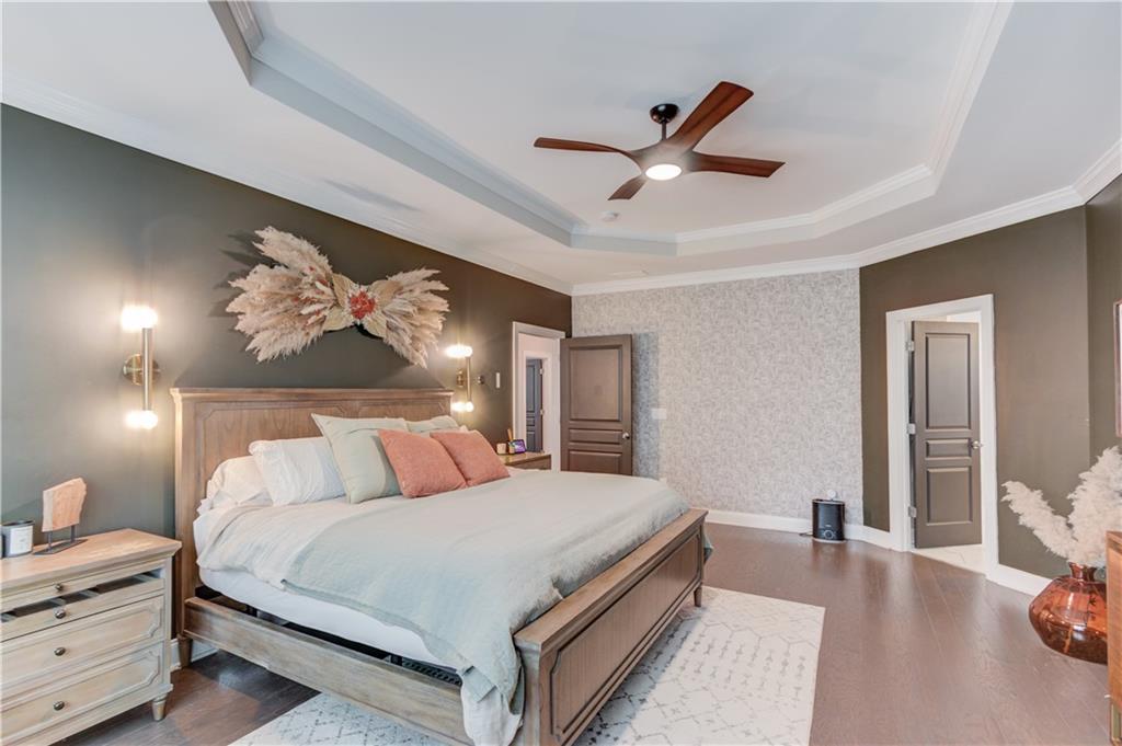 542 Flyingbolt Run Canton, GA 30115 - Photo 25 of 55 a bedroom with a bed and a chandelier