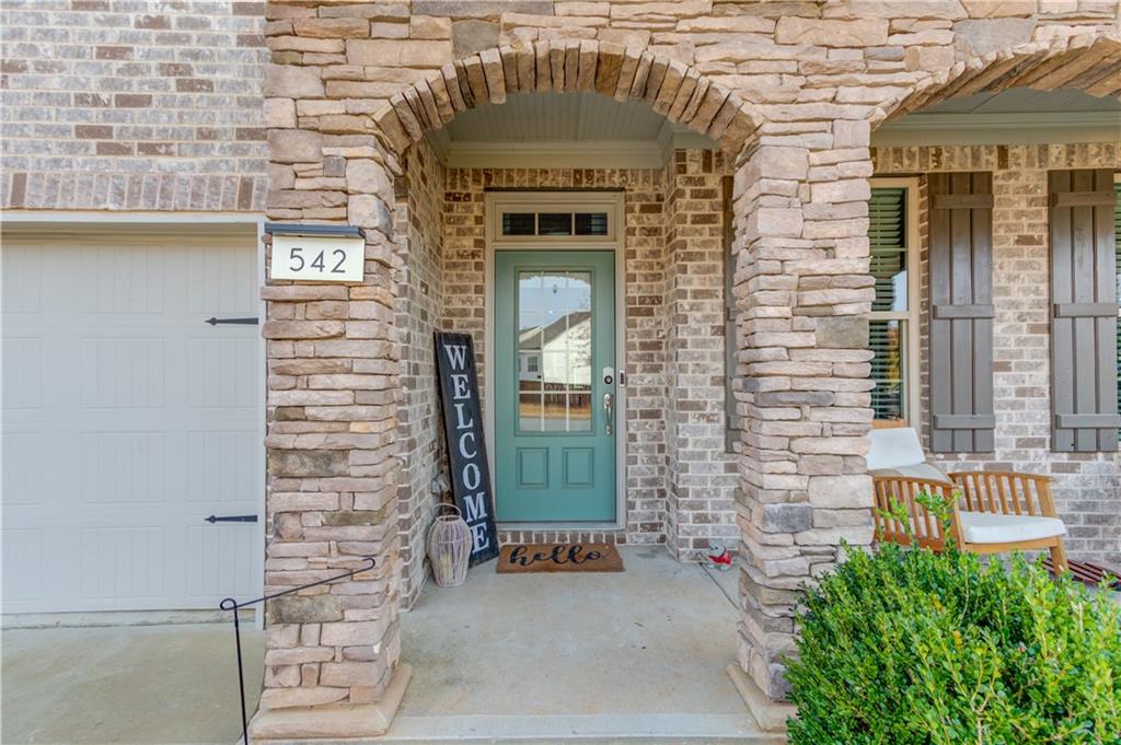 542 Flyingbolt Run Canton, GA 30115 - Photo 3 of 55 a front view of a house with a garden