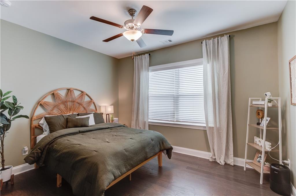 542 Flyingbolt Run Canton, GA 30115 - Photo 32 of 55 a bedroom with a large bed and a chandelier