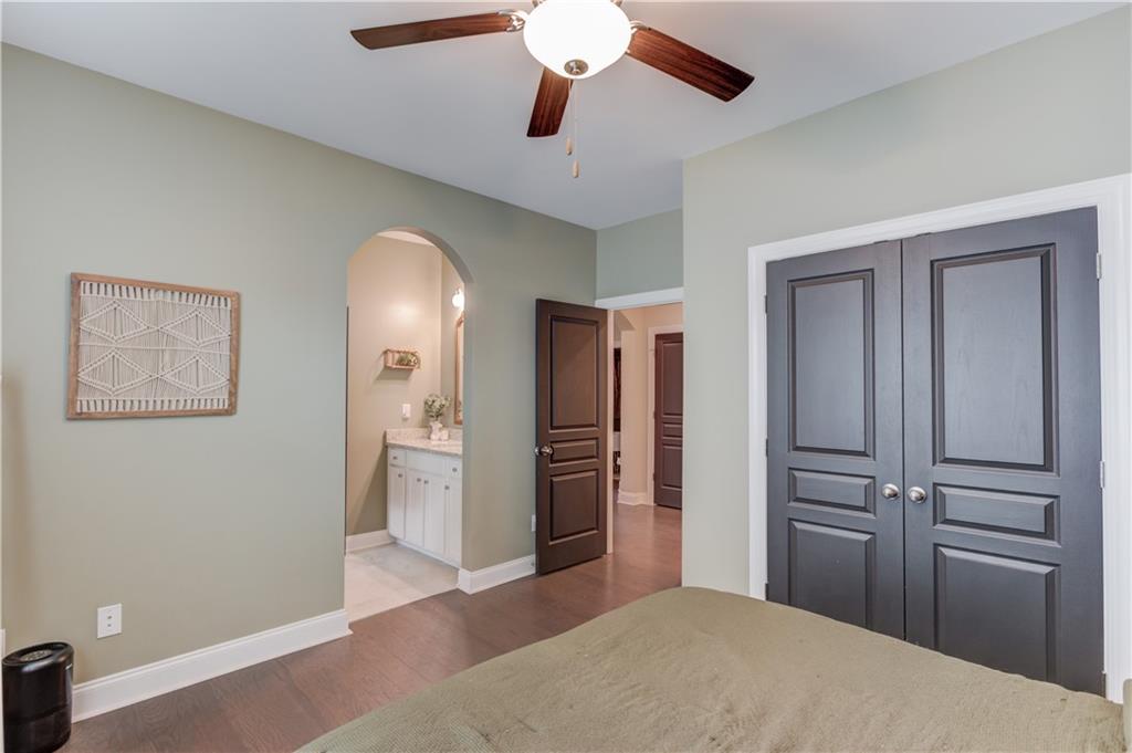 542 Flyingbolt Run Canton, GA 30115 - Photo 33 of 55 a bedroom with a bed and a chandelier