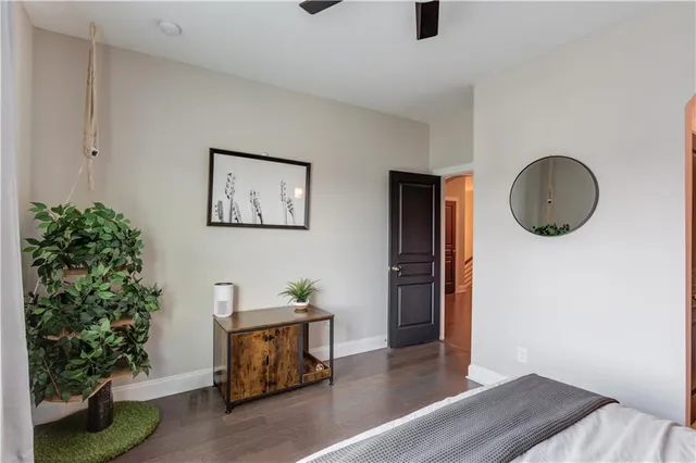 a bathroom with a granite countertop sink a toilet and a mirror