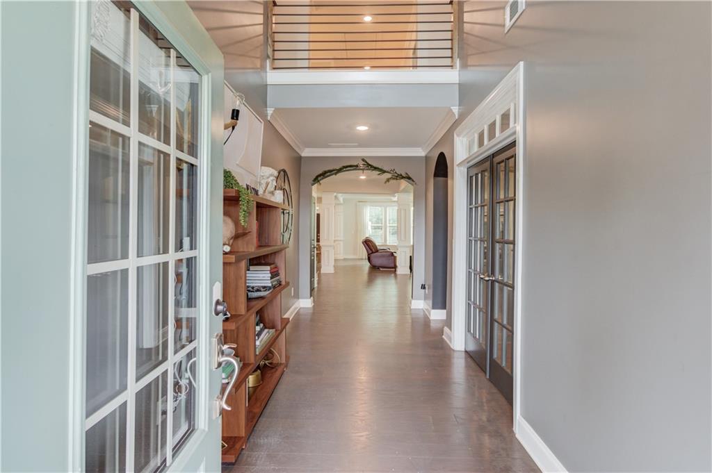 542 Flyingbolt Run Canton, GA 30115 - Photo 4 of 55 a view of a hallway with wooden floor and staircase