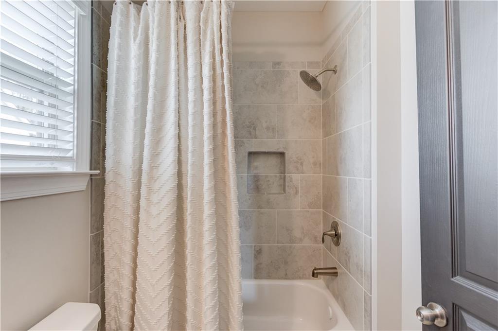 542 Flyingbolt Run Canton, GA 30115 - Photo 41 of 55 a bathroom with a shower and a toilet