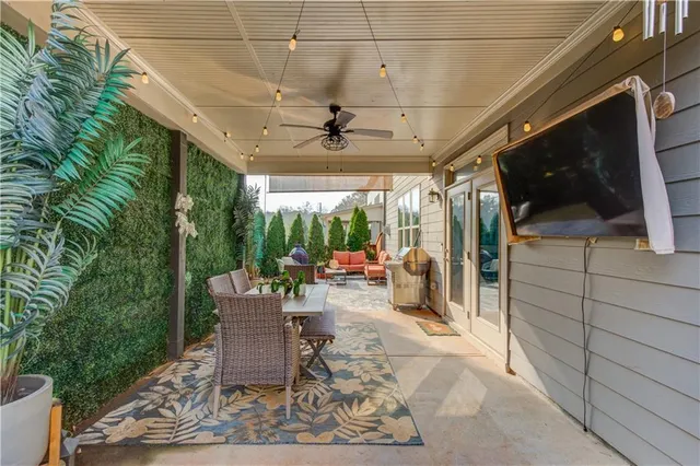a view of a chair and table in backyard of the house