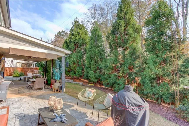 a view of a patio with table and chairs and potted plants