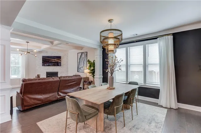 a view of a dining room with furniture wooden floor and chandelier