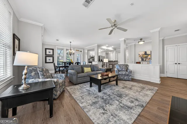 a living room with furniture and wooden floor