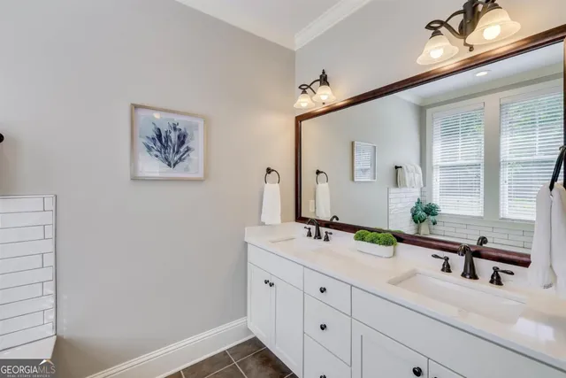 a bathroom with a double vanity sink and a mirror