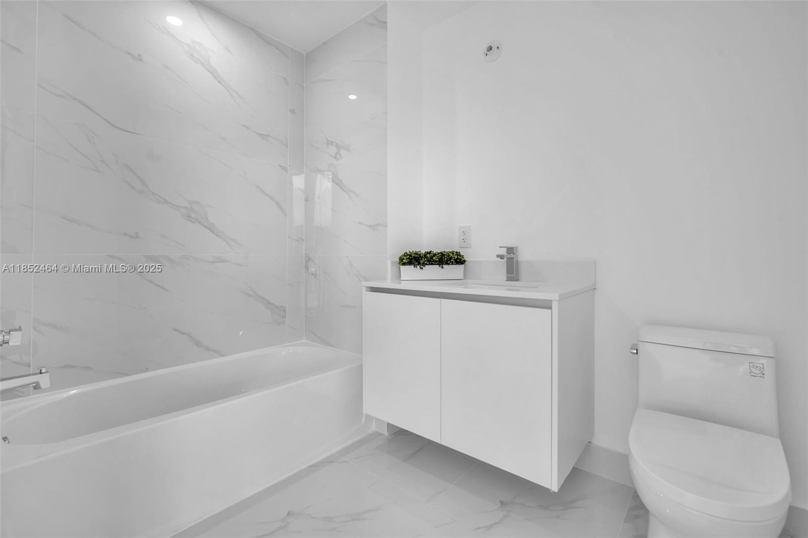 700 Northeast 24th Street, Unit 4507 Miami, FL 33137 - Photo 36 of 70 a bathroom with a sink a toilet and bathtub