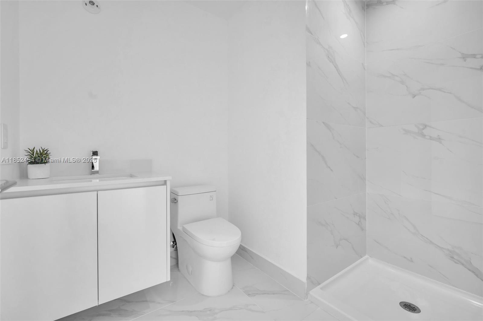 700 Northeast 24th Street, Unit 4507 Miami, FL 33137 - Photo 39 of 70 a bathroom with a sink a toilet and shower