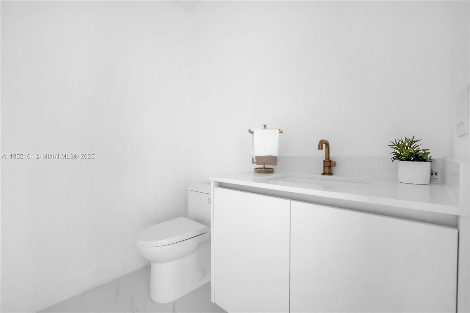 700 Northeast 24th Street, Unit 4507 Miami, FL 33137 - Photo 42 of 70 a bathroom with a sink a toilet and a mirror