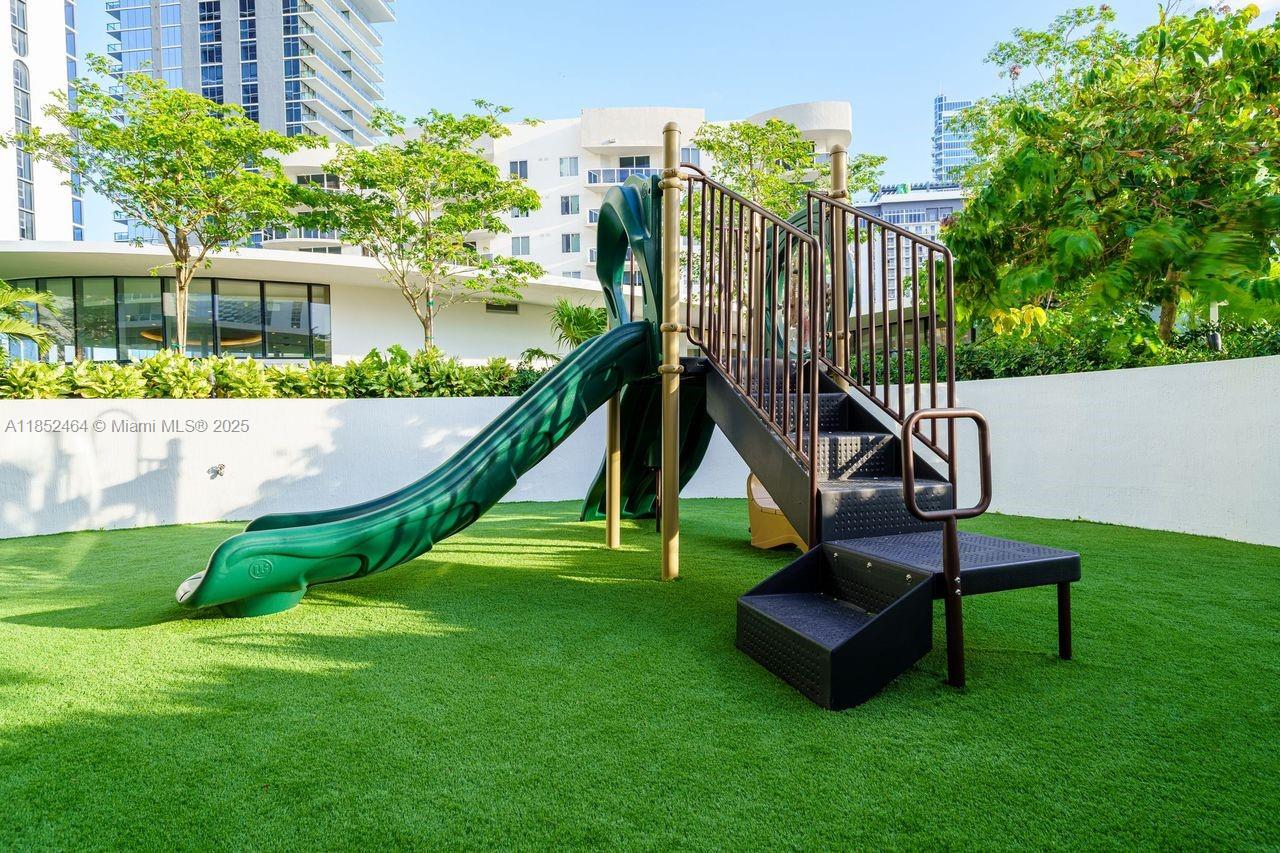 700 Northeast 24th Street, Unit 4507 Miami, FL 33137 - Photo 54 of 70 a view of a garden with a slide