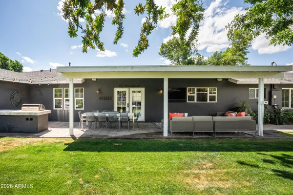 a front view of house with yard and outdoor seating
