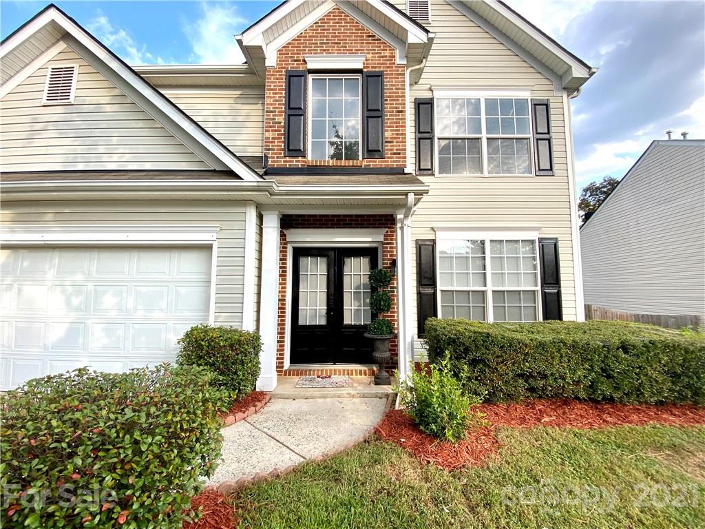 a front view of a house with a yard