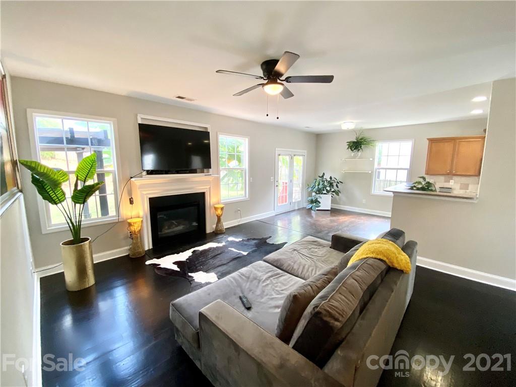 11414 Erwin Ridge Avenue Charlotte, NC 28213 - Photo 3 of 11 a living room with furniture a flat screen tv and a fireplace