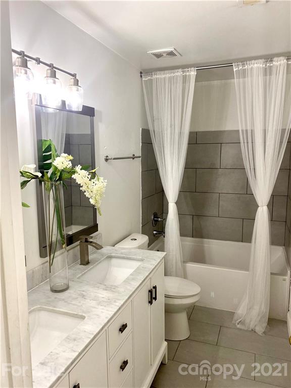 11414 Erwin Ridge Avenue Charlotte, NC 28213 - Photo 8 of 11 a bathroom with a granite countertop sink toilet and shower