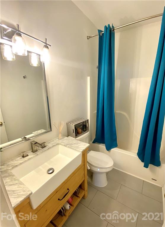 11414 Erwin Ridge Avenue Charlotte, NC 28213 - Photo 9 of 11 a bathroom with a sink a toilet a mirror and shower