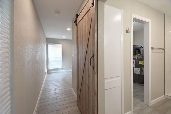 a view of a hallway with a wooden door