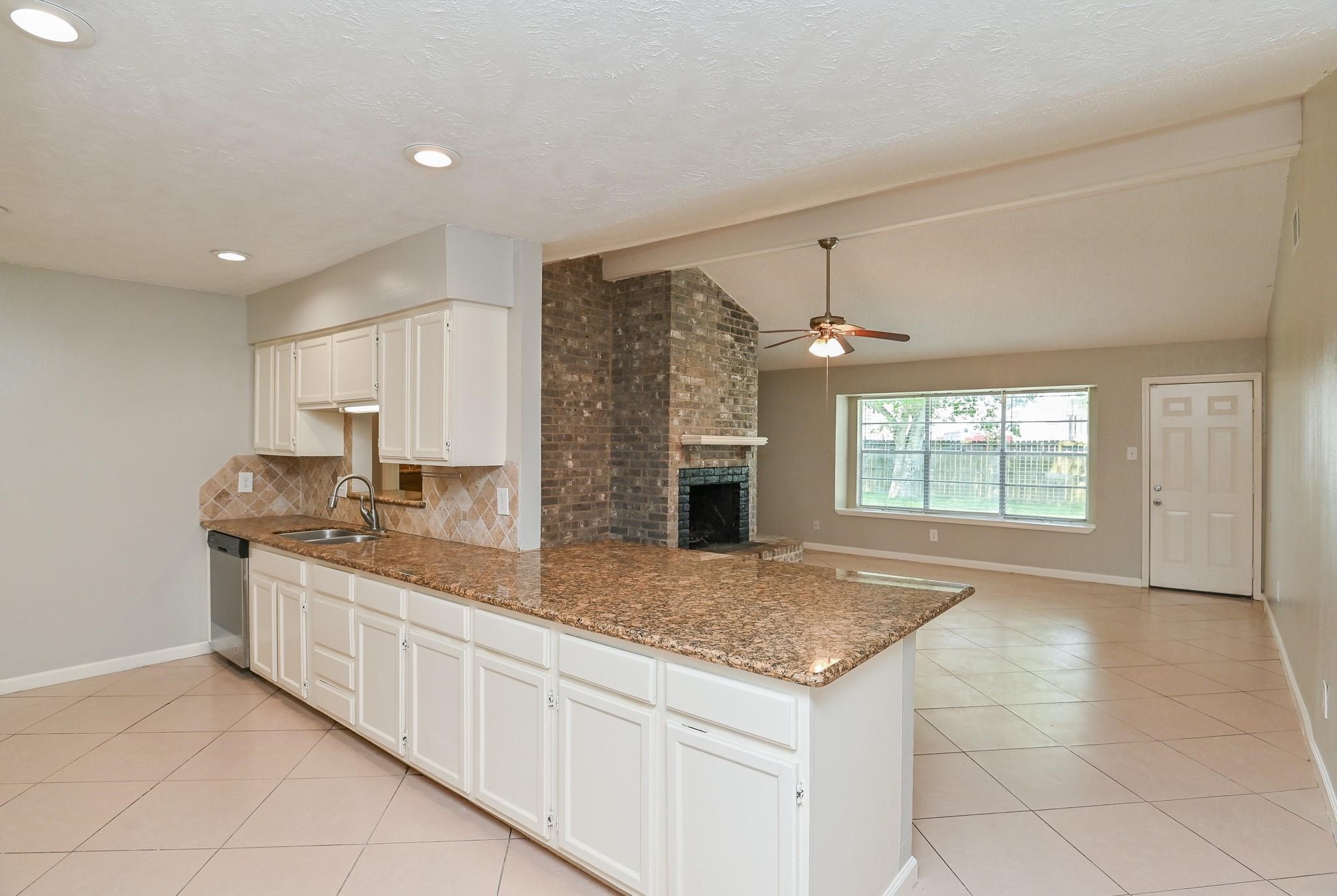 10019 Overview Drive Sugar Land, TX 77498 - Photo 11 of 30 a kitchen with stainless steel appliances granite countertop a sink and a stove