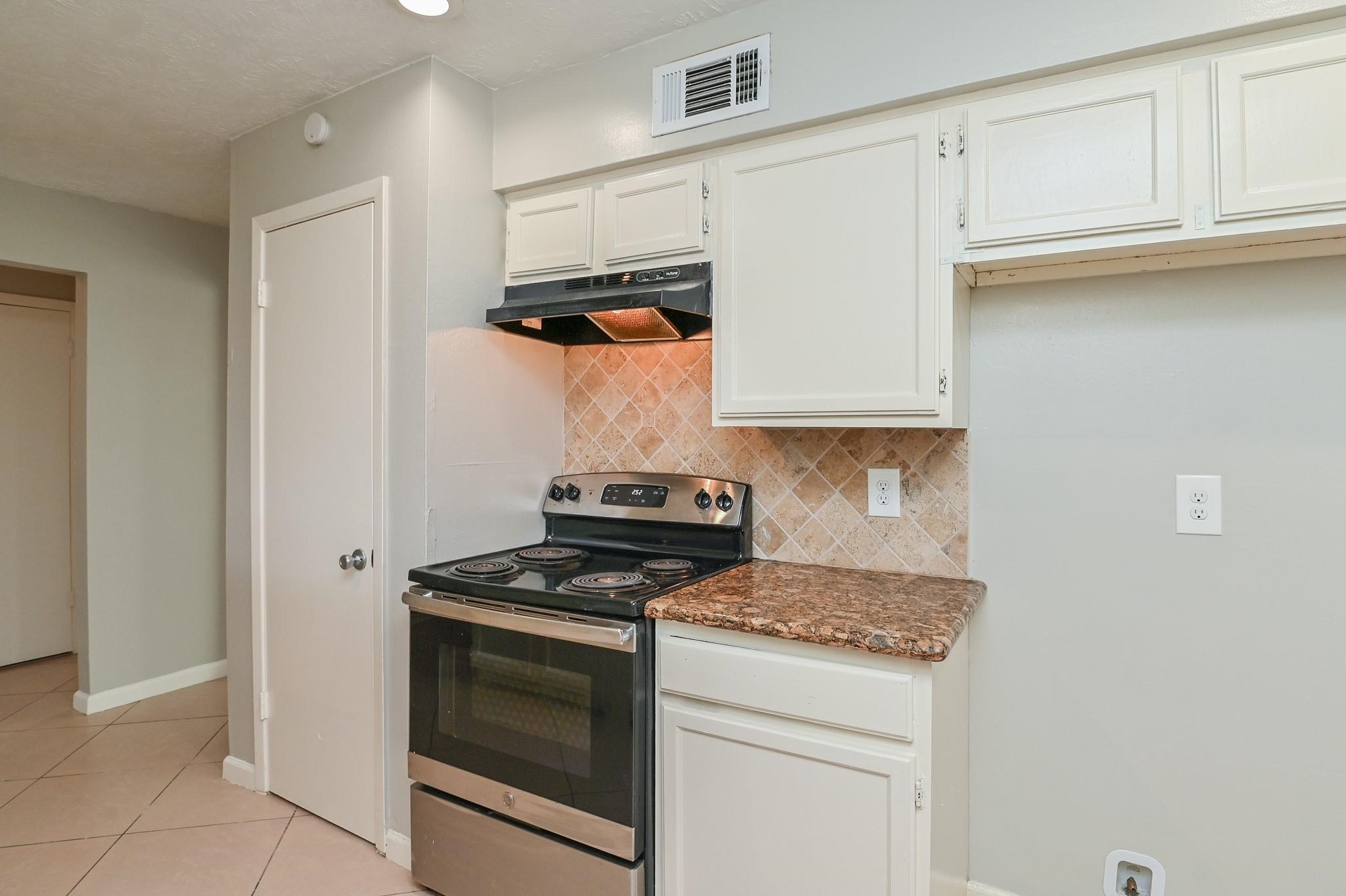 10019 Overview Drive Sugar Land, TX 77498 - Photo 15 of 30 a kitchen with stainless steel appliances granite countertop white cabinets and a stove