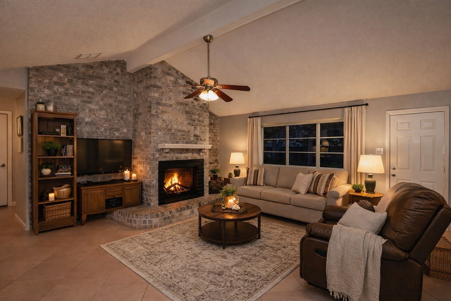 10019 Overview Drive Sugar Land, TX 77498 - Photo 7 of 30 a living room with furniture a flat screen tv and a fireplace