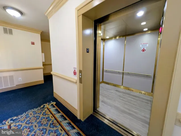 a view of hallway with stairs and wooden floor