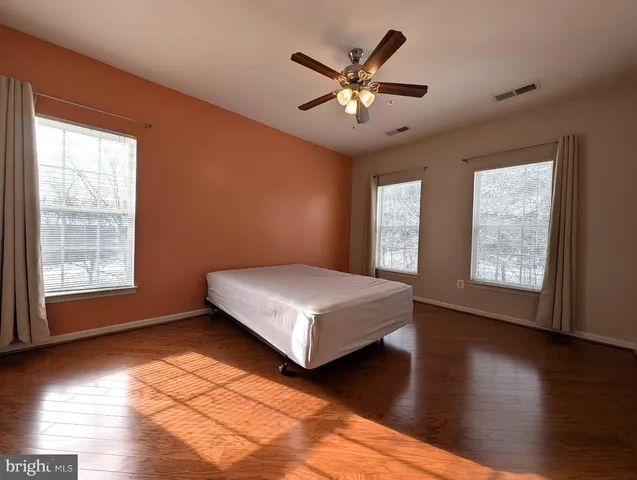 a bedroom with a large bed and a window