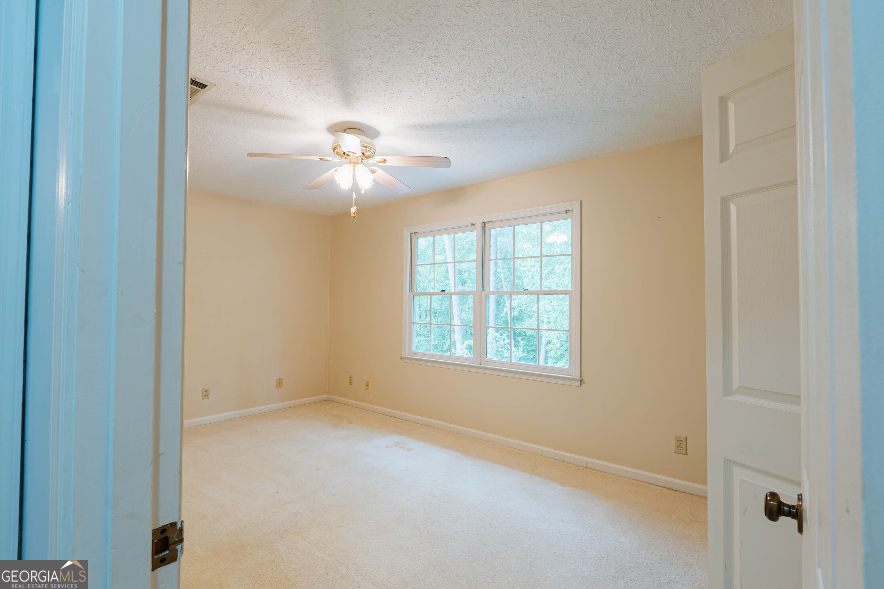 139 Cords Bridge Road Northeast Milledgeville, GA 31061 - Photo 27 of 35 an empty room with chandelier fan and windows