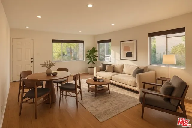 a living room with furniture a table and a large window