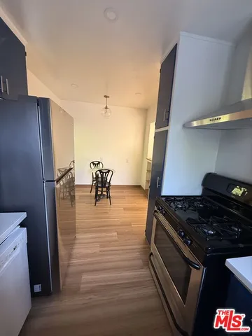 a kitchen with granite countertop a stove and a refrigerator