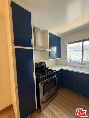 a kitchen with granite countertop stainless steel appliances and wooden cabinets