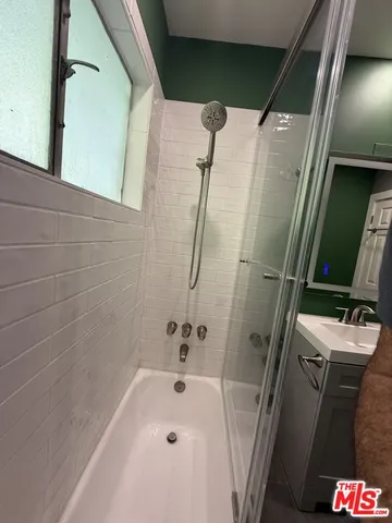 a bathroom with a bathtub and a shower