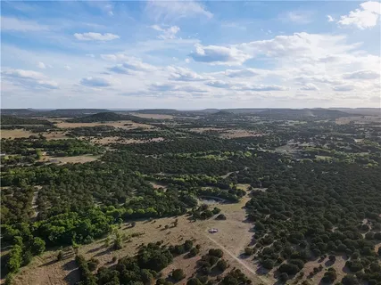 a view of a street with a forest