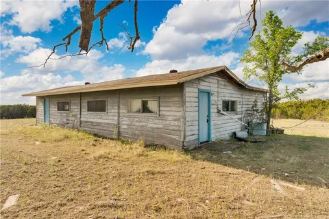 a house view with wooden fence and fence