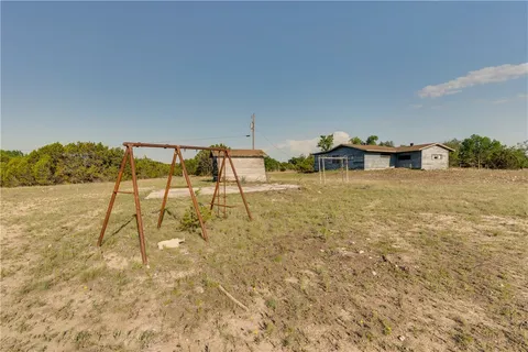 a view of a parking space with wooden walls
