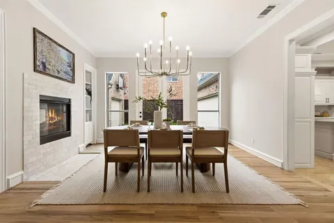 a dining room with furniture a chandelier and wooden floor